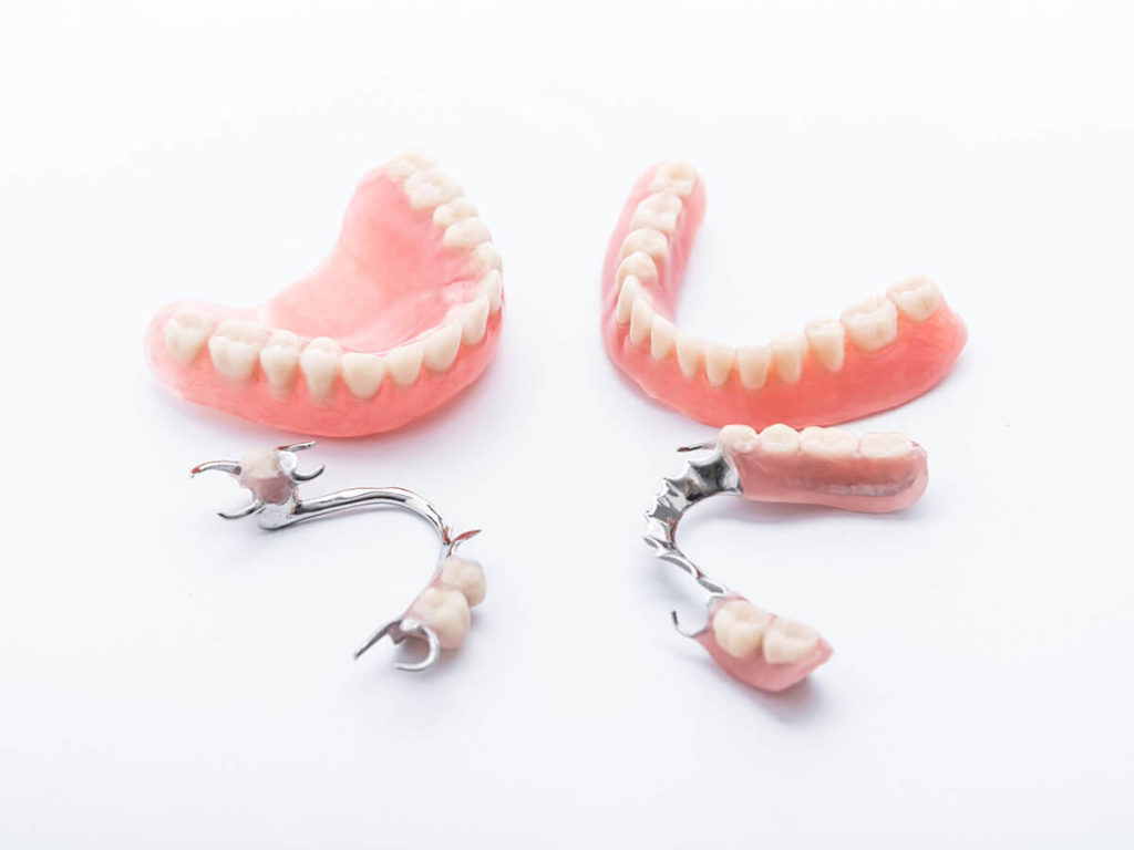 full and partial dentures on a white background