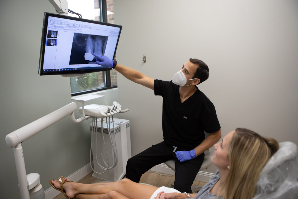 Image of Dr. Andy Pernell reviewing dental x-rays with a patient at Summit Family Dentistry in Denver, North Carolina