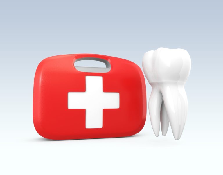 red first-aid kit with a white cross next to a white tooth representing emergency dentistry services at Summit Family Dentistry in Denver, North Carolina